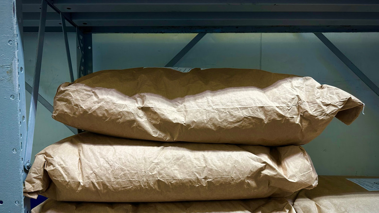 Sacks for flour on a shelf.