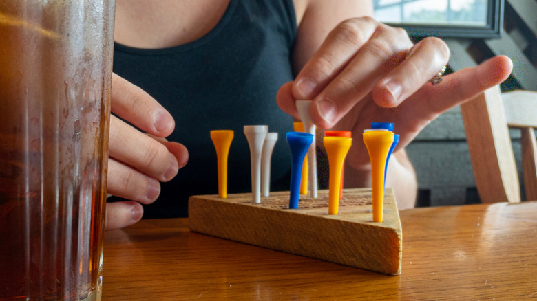Person playing with a Cracker Barrel peg board game