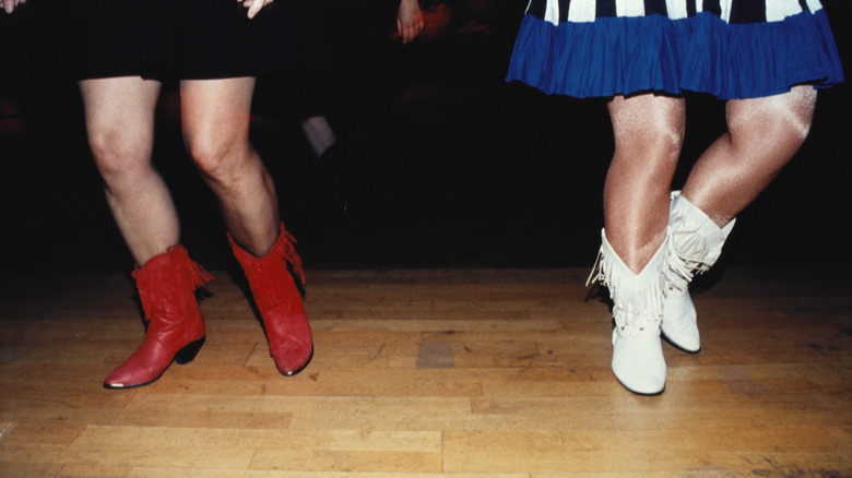 Legs of two people line dancing