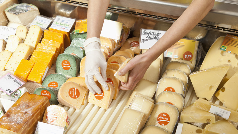 Rows of cheese pieces lined up in a deli case