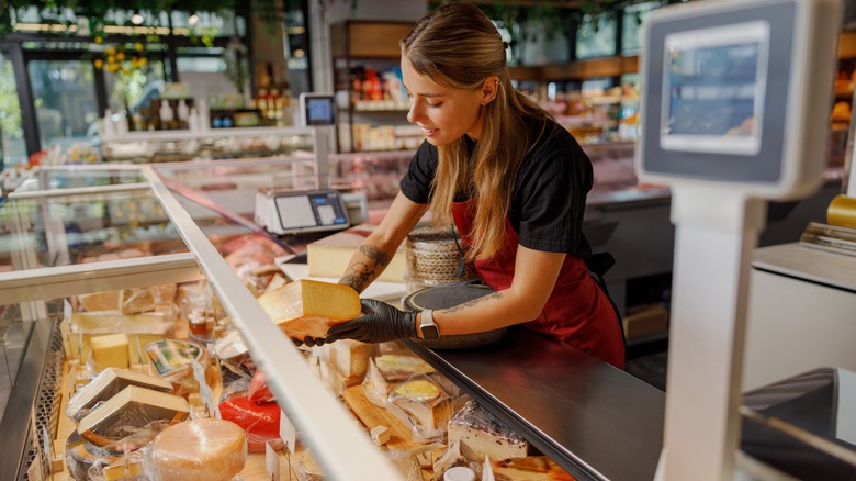 woman serving at deli