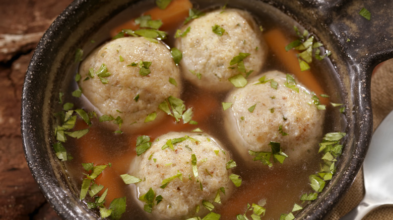 Four matzo balls in broth