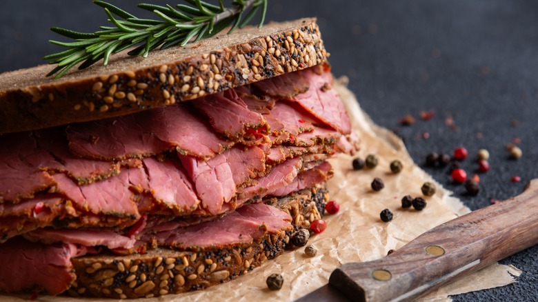 slices of pastrami piled on a sandwich
