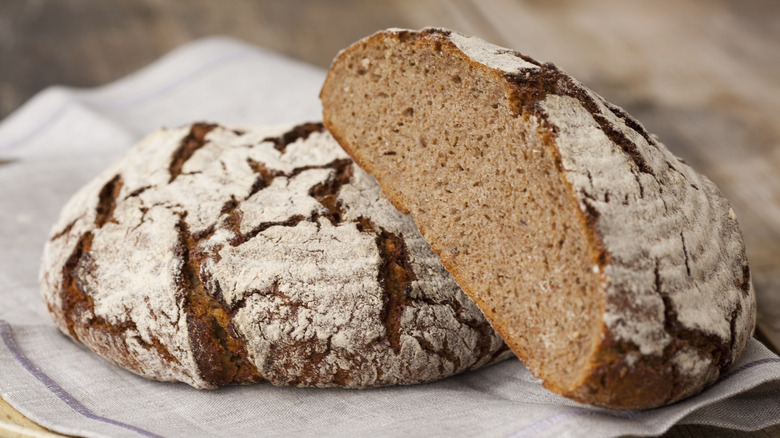 A fresh loaf of rye bread, cut in half