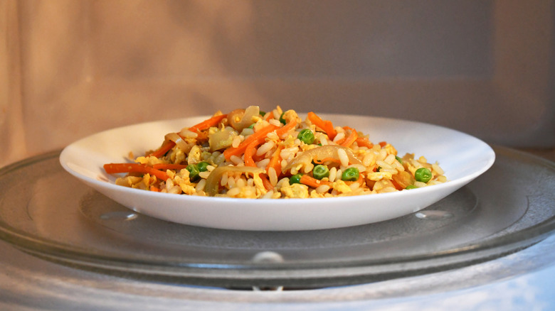A plate of food sitting inside of a microwave.