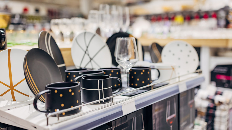 Dishware sets, shown on a store shelf.