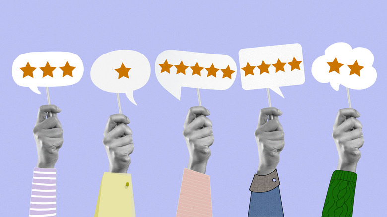Five separate hands hold signs with review stars on them.