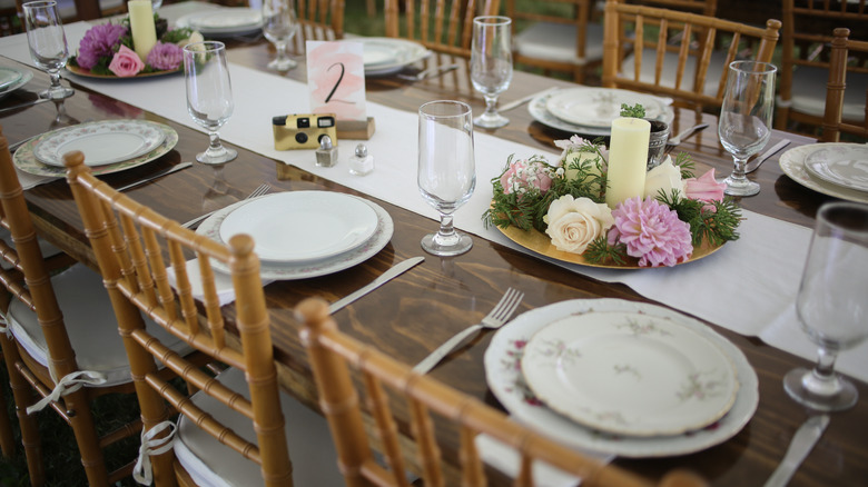 A table is set with mismatched dinner and salad plates.