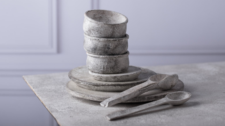 Stone bowls, plates, and spoons on counter