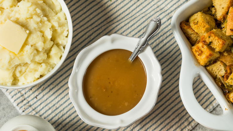 Homemade Thanksgiving turkey gravy in a bowl for potatoes