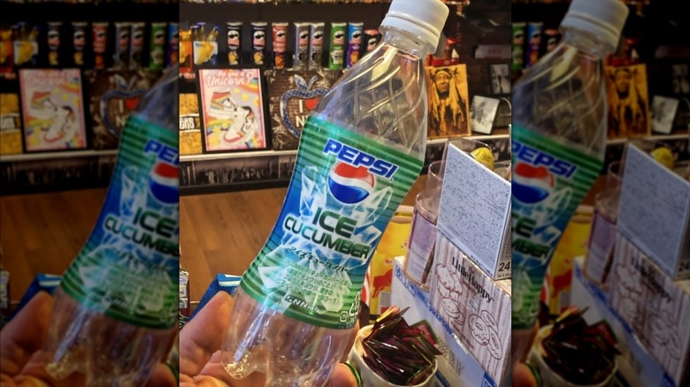 A plastic bottle of Ice Cucumber Pepsi with a grocery store shelf in the background