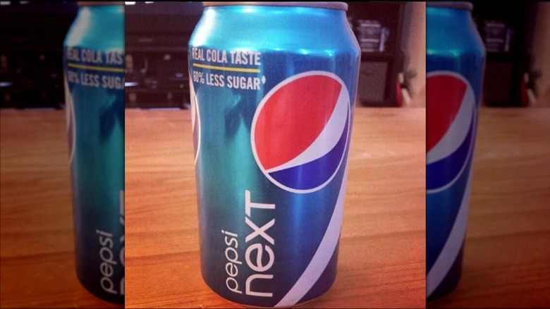 A can of Pepsi Next on a wooden table