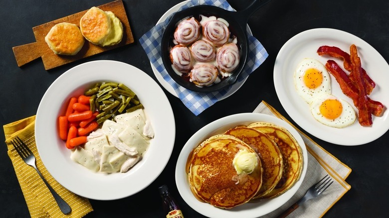 An assortment of starter and entree dishes served at Cracker Barrel are placed on a table