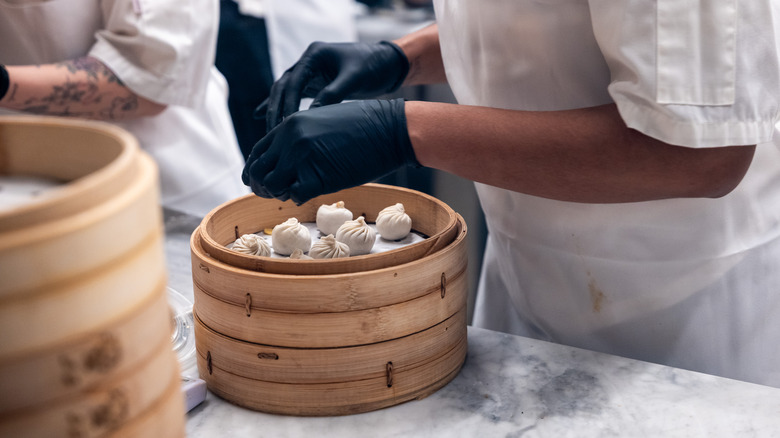Staff make dumplings at the Taiwanese restaurant chain Din Tai Fung