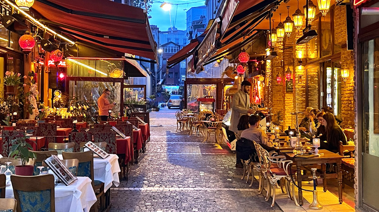 City life, street cafe in the evening on the narrow street