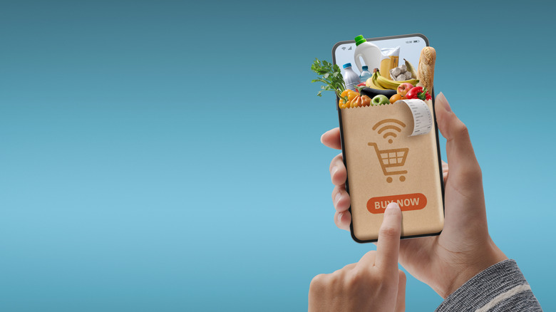 Online grocery shopping app on a phone with a finger swiping