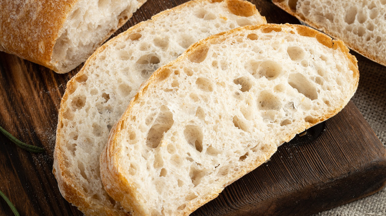 Sliced homemade bread on a wooden cutting board