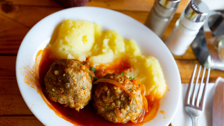 Meatballs with mashed potatoes on a white plate