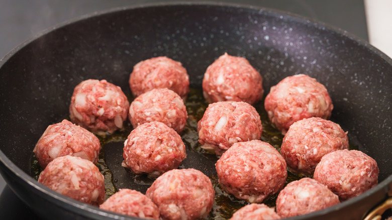 Raw meatballs in a pan