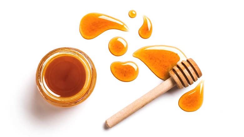 Caramel Honey Swirl sauce in glass jar with honey spoon