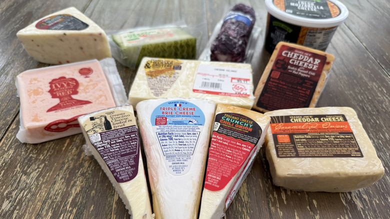 A selection of Trader Joe's packaged cheeses on wooden table
