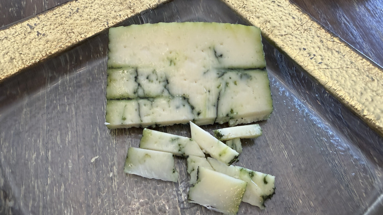 Trader Joe's Sheepish Pesto cheese on gold rimmed plate