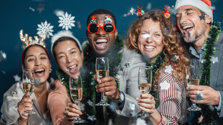 people holding wine glasses at a New Year's party