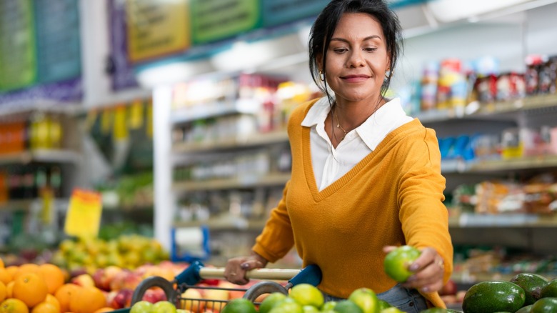 Customer chooses lemon in a neighborhood store