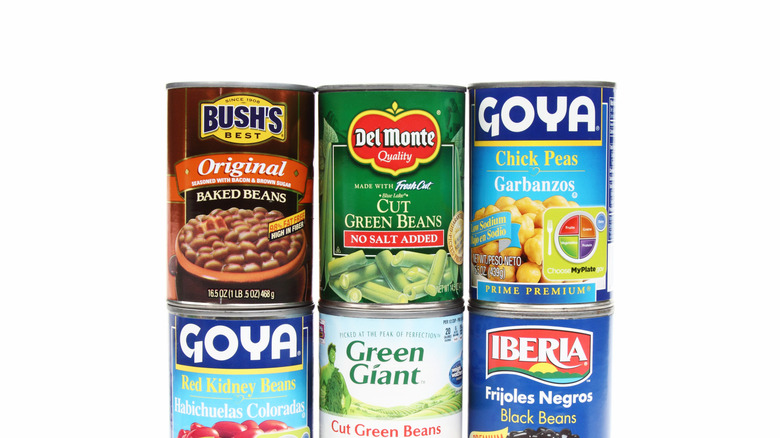 A studio shot of an assortment of different types and brands of canned beans