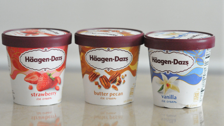 Containers of Haagen-Dazs ice cream in Vanilla, Butter Pecan, and Strawberry flavors