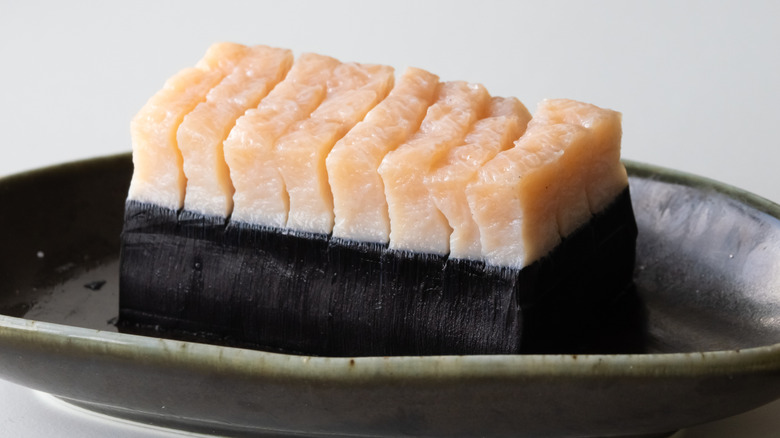Cubes of mattak rest in a black dish.