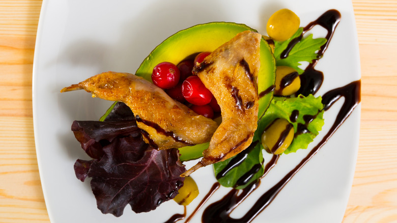 Grilled ptarmigan ontop of vegetables, with balsamic sauce