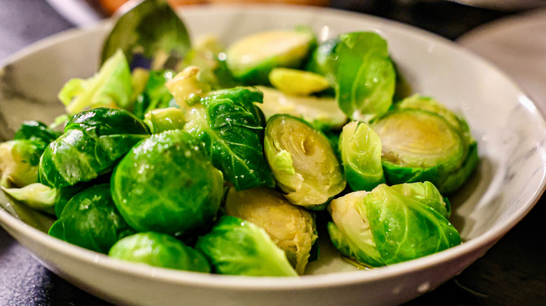 A bowl of cooked and seasoned Brussels sprouts