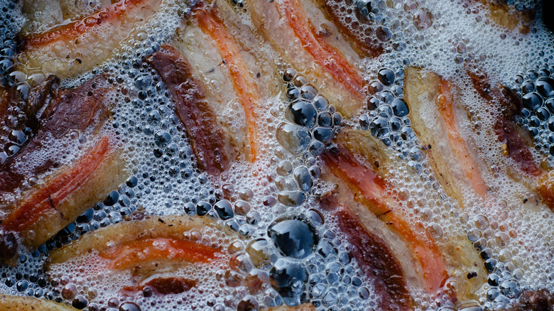 Bacon frying in fat and oil