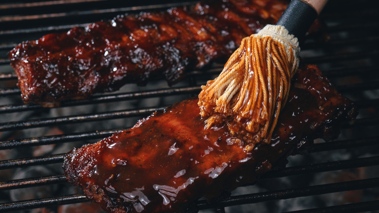 Sauce mop on ribs on the grill