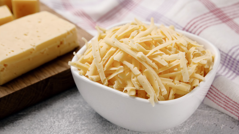 White bowl of shredded cheese