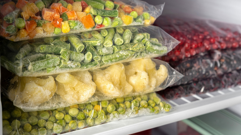 Bags of frozen vegetables in freezer