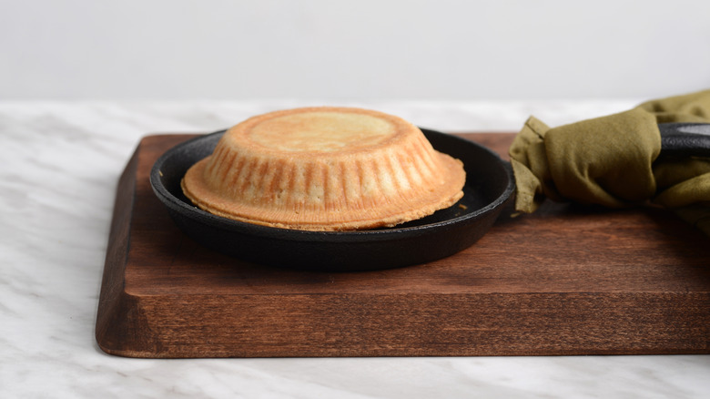 Pot pie flipped over on a wooden board