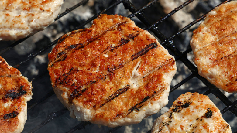 Chicken burgers cooking on the grill