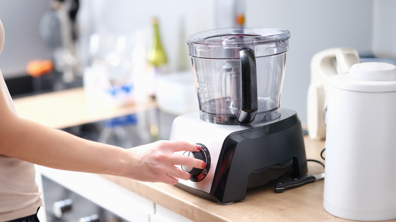 Woman's hand testing food processor