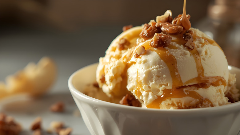 Vanilla ice cream with caramel and pecans on top