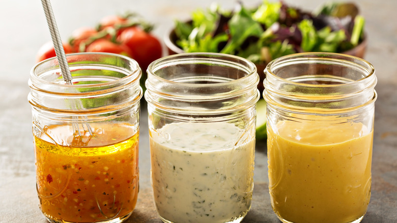 Three homemade sauces in glass mason jars