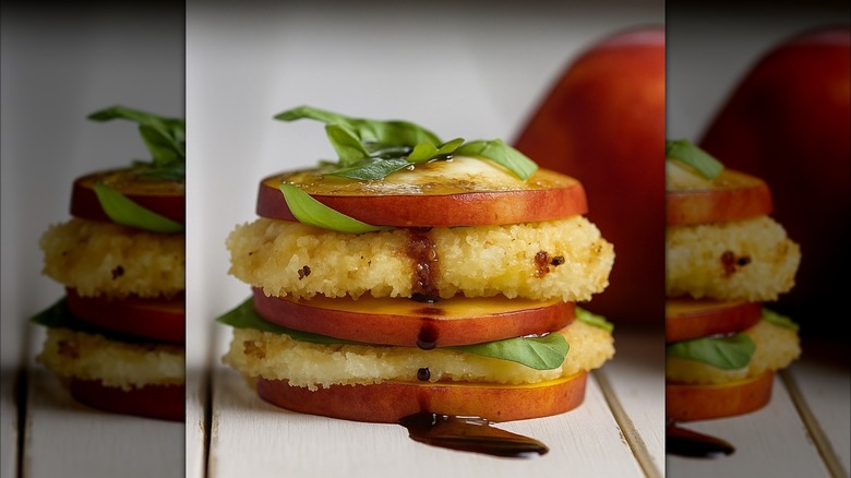 Two pieces of fried mozzarella layered with three rounds of nectarine and drizzled with balsamic.