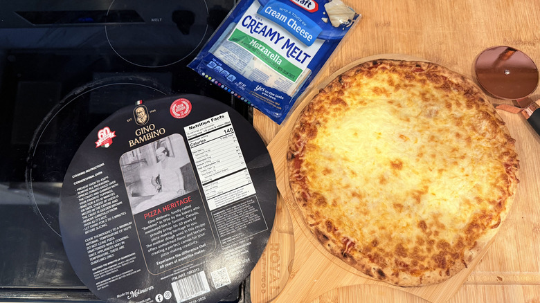 Pizza kit showing cooked pizza with cheese and a pizza cutter