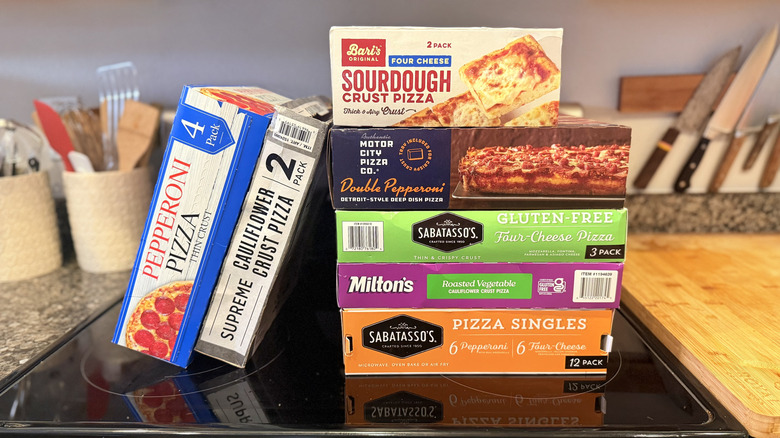 Stacked pizza boxes on top of oven