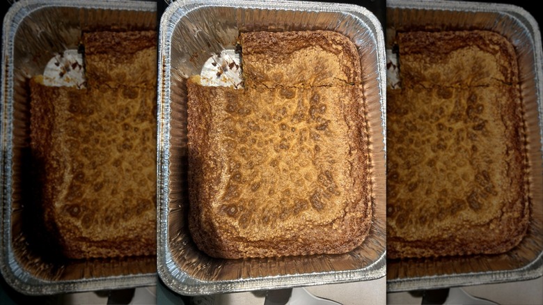 Chew bread in a foil tray with a square slice missing