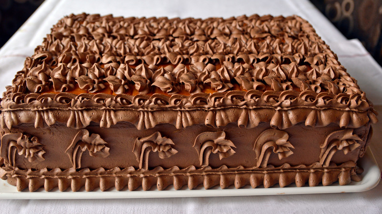 Doberge cake on a white tray
