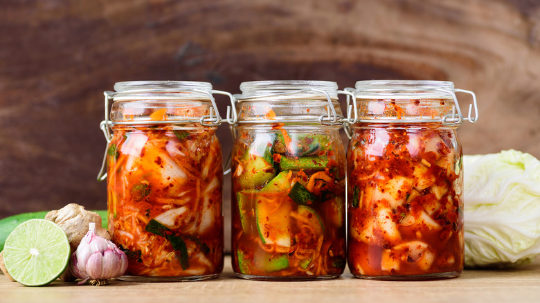 Three glass jars of kimchi
