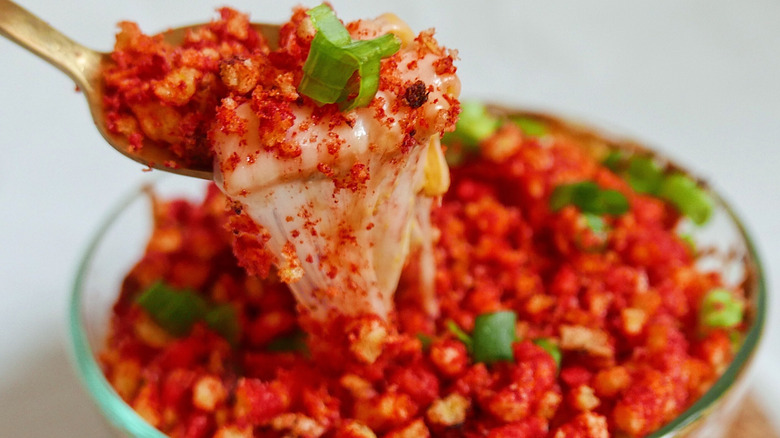 A close-up of mac and cheese topped with a red powder