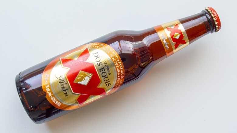 Bottle of Dos Equis Ambar lying down